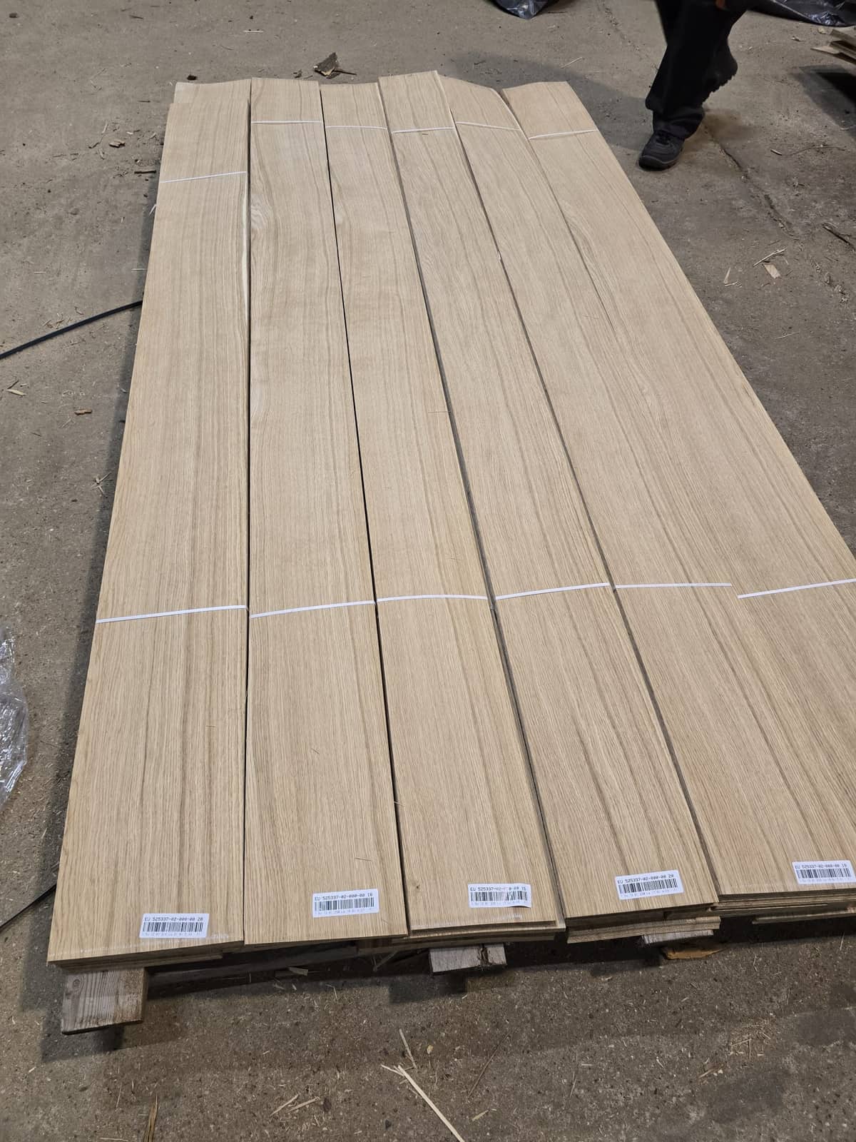 Oak veneer on a pallet with batch labels on the leaf ends