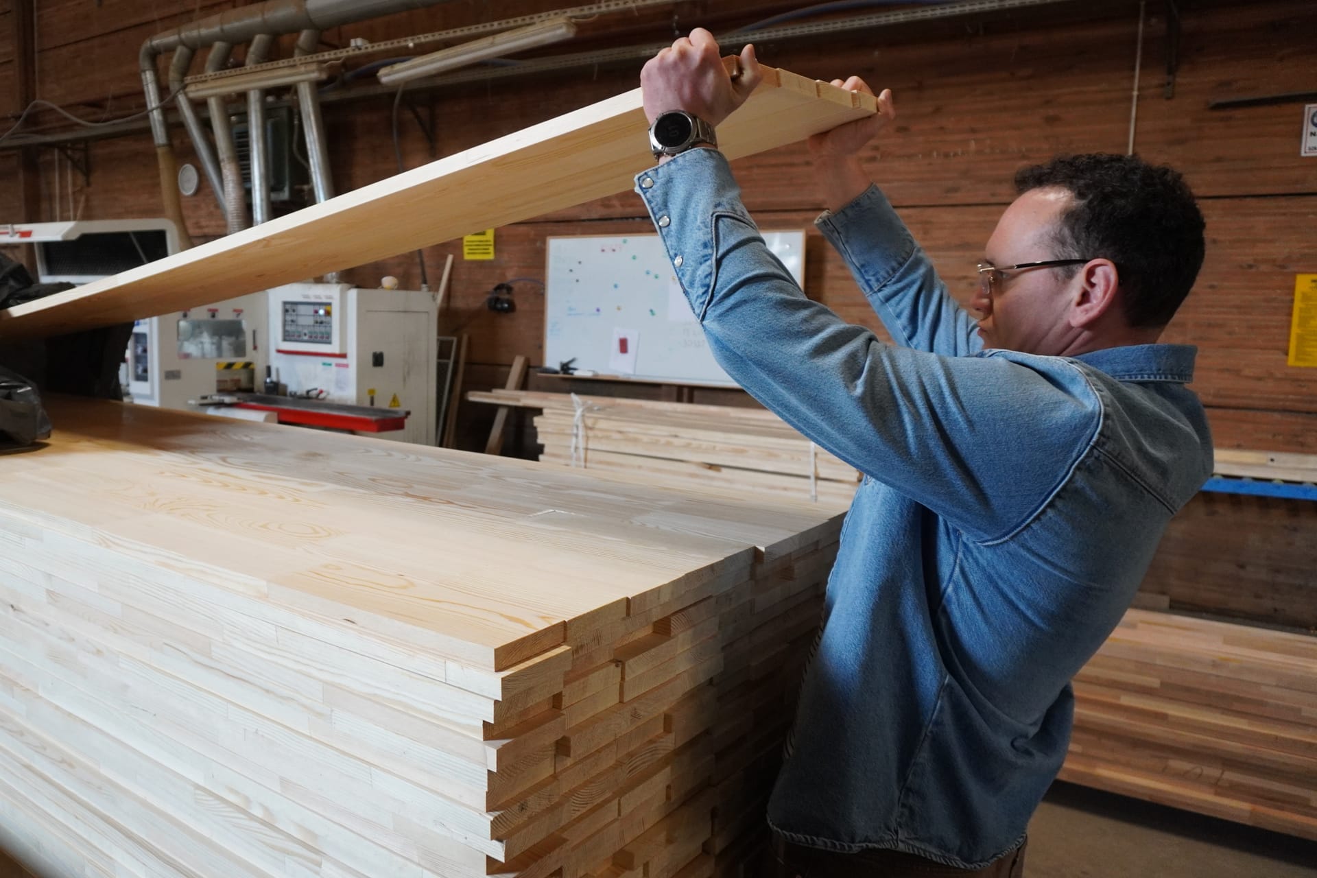 Checking a glued beam against the light in the hall